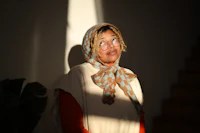 a woman wearing glasses and a scarf