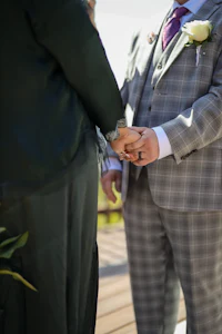 a man and woman are holding hands during a wedding ceremony