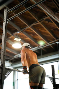 a man doing squats in a gym