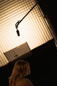 a woman is standing in front of a camera