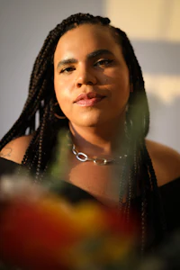 a woman in a black dress is posing for a photo