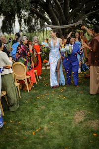 a group of people standing in a grassy area