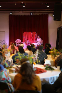 a group of people sitting at tables in a room