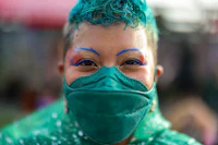 a woman wearing a green face mask
