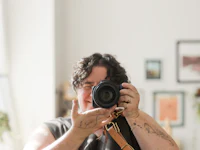 a woman taking a picture of herself with a camera